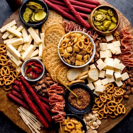 Game day charcuterie board on round wood tray.