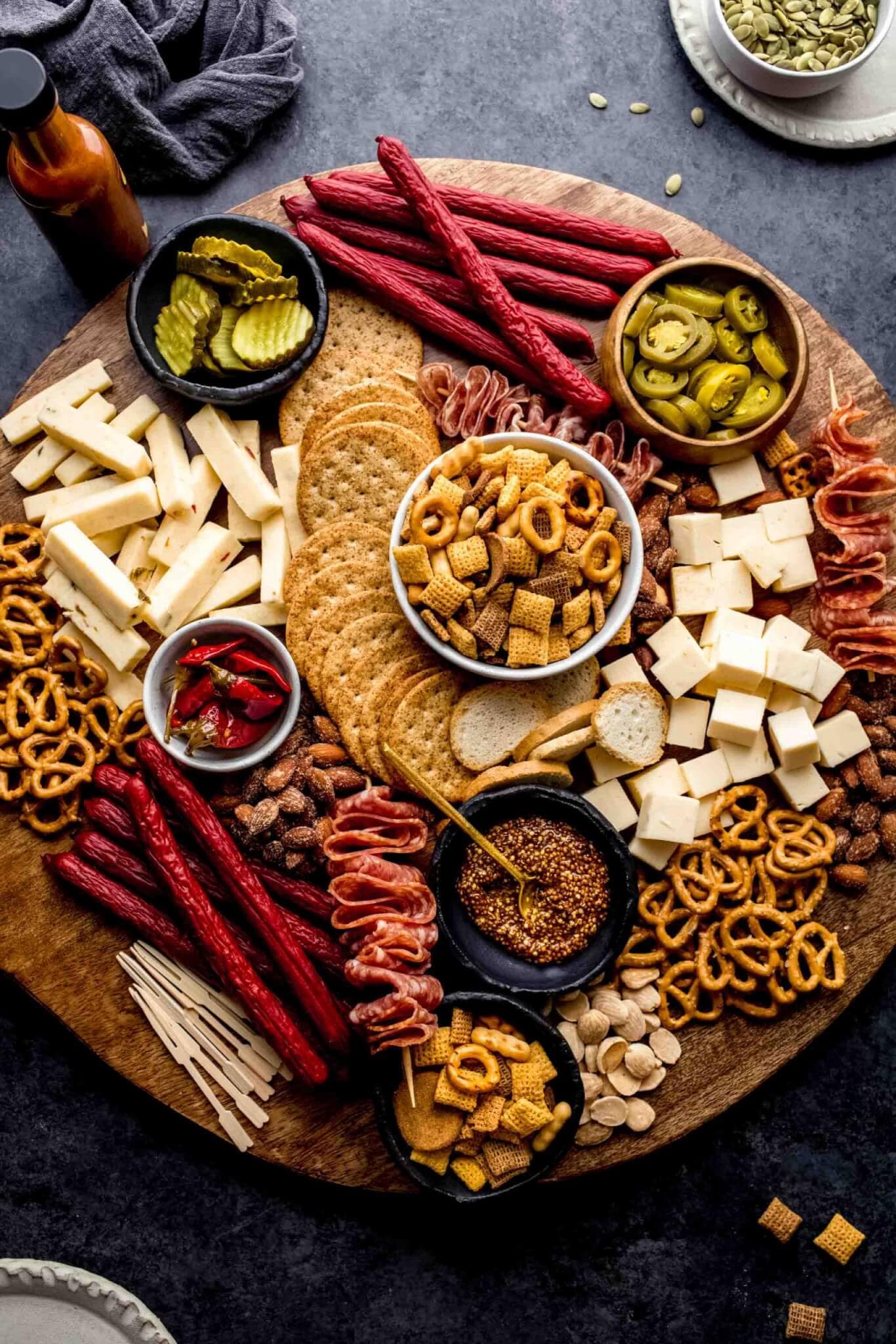 Game day charcuterie board on round wood tray.