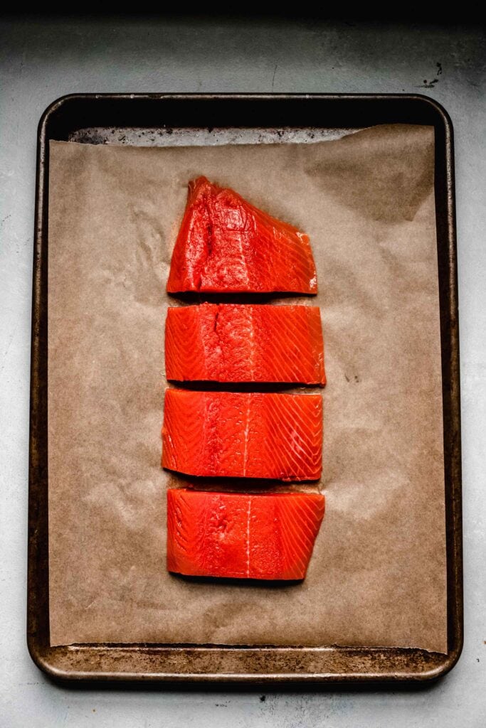 Filet of salmon on baking sheet lined with parchment. 