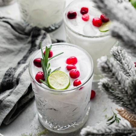 Three white Christmas Margaritas on counter with Christmas decor