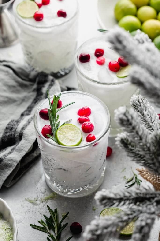 Three white Christmas Margaritas on counter with Christmas decor