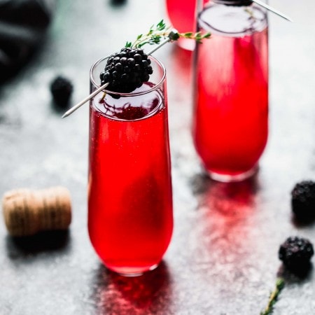 This Blackberry Champagne Cocktail is a festive sparkling cocktail that's perfect for holiday parties. Or, try this blackberry mimosa for brunch! // blackberry bellini