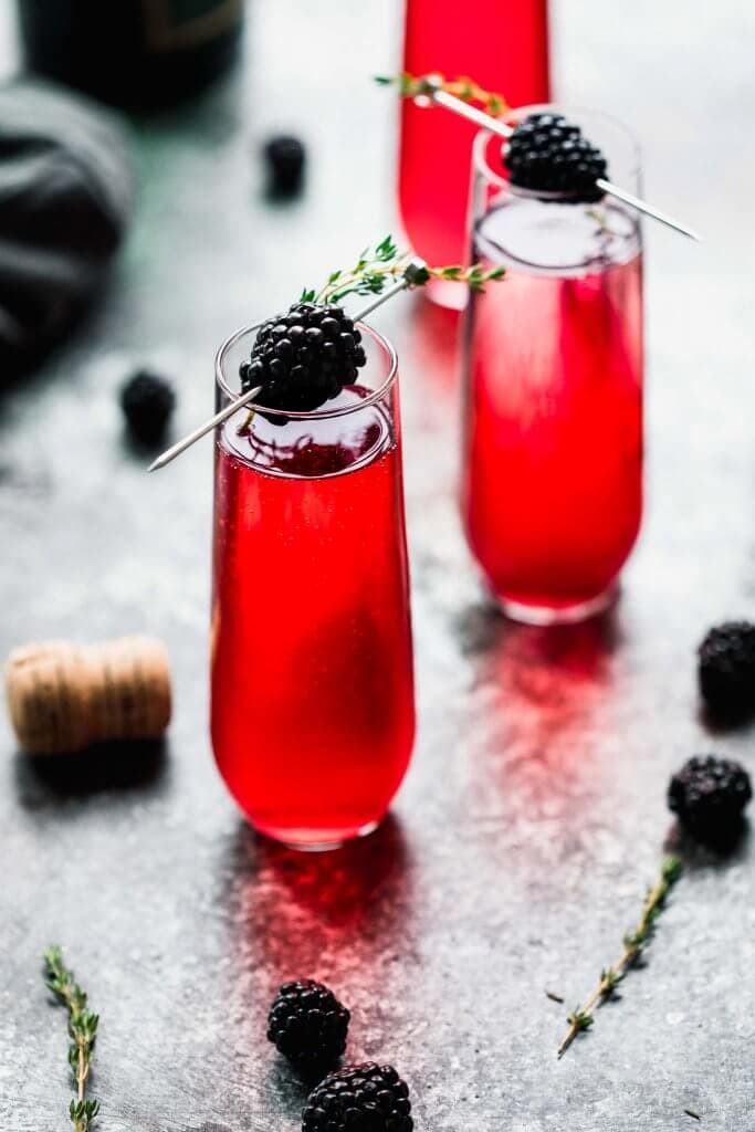 This Blackberry Champagne Cocktail is a festive sparkling cocktail that's perfect for holiday parties. Or, try this blackberry mimosa for brunch! // blackberry bellini