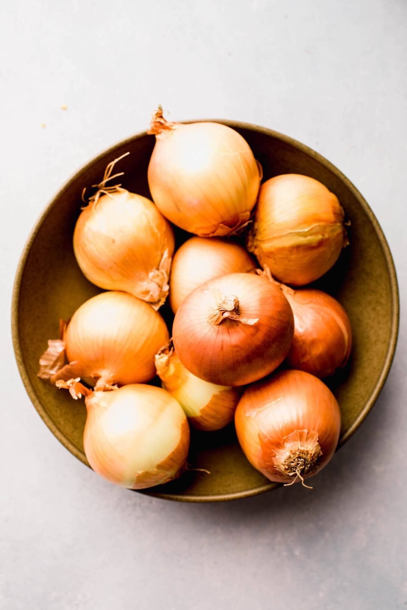 Whole onions in bowl before being sliced.