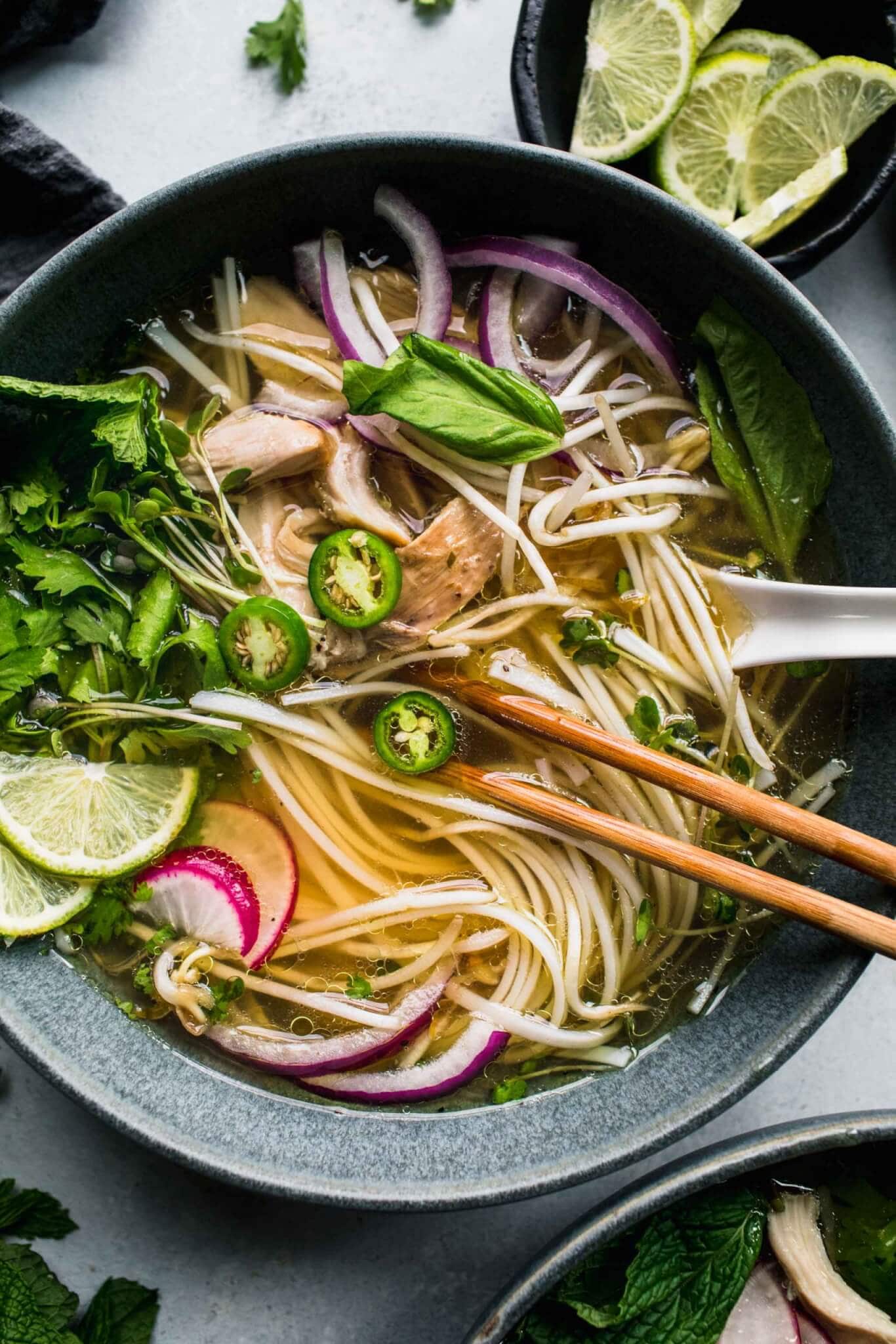 Overhead close up of bowl of pho with toppings.