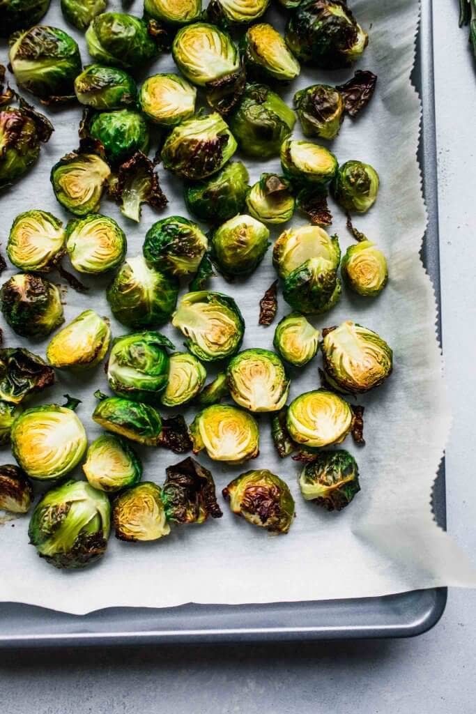 Crispy roasted brussel sprouts on baking sheet.