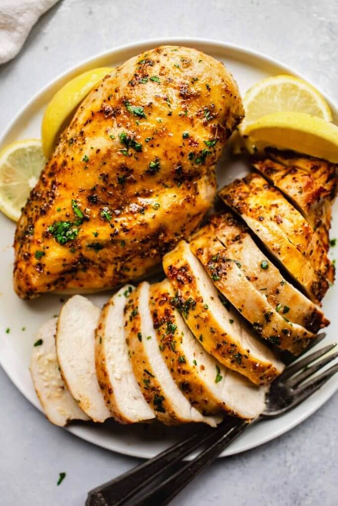 Sliced chicken breast on white plate.