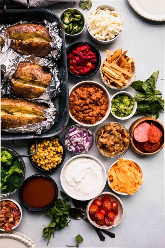 Baked potato bar set up on counter.