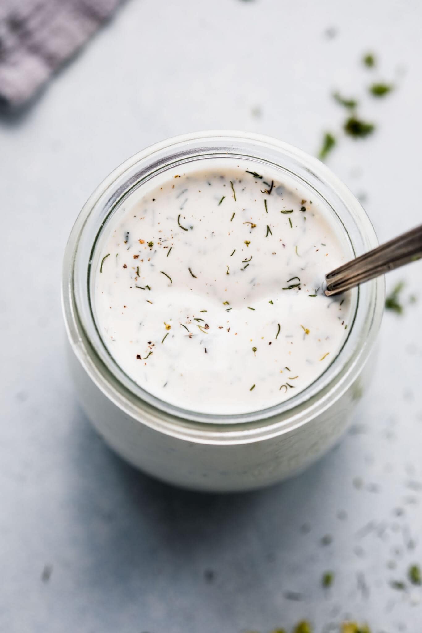 Ranch dressing in small glass jar with spoon.