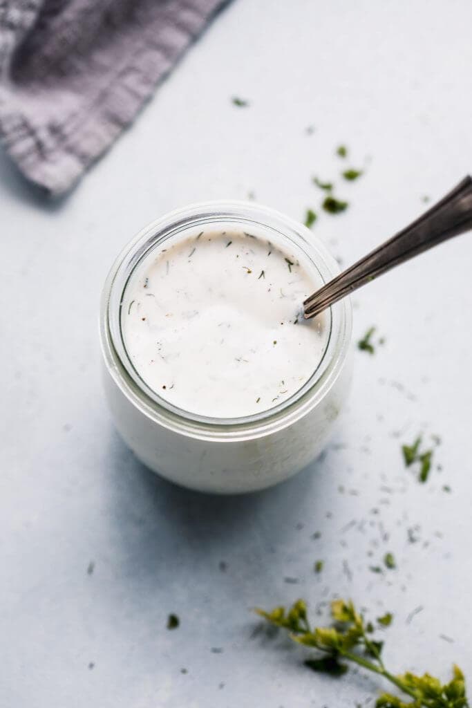 Ranch in small jar with spoon. 