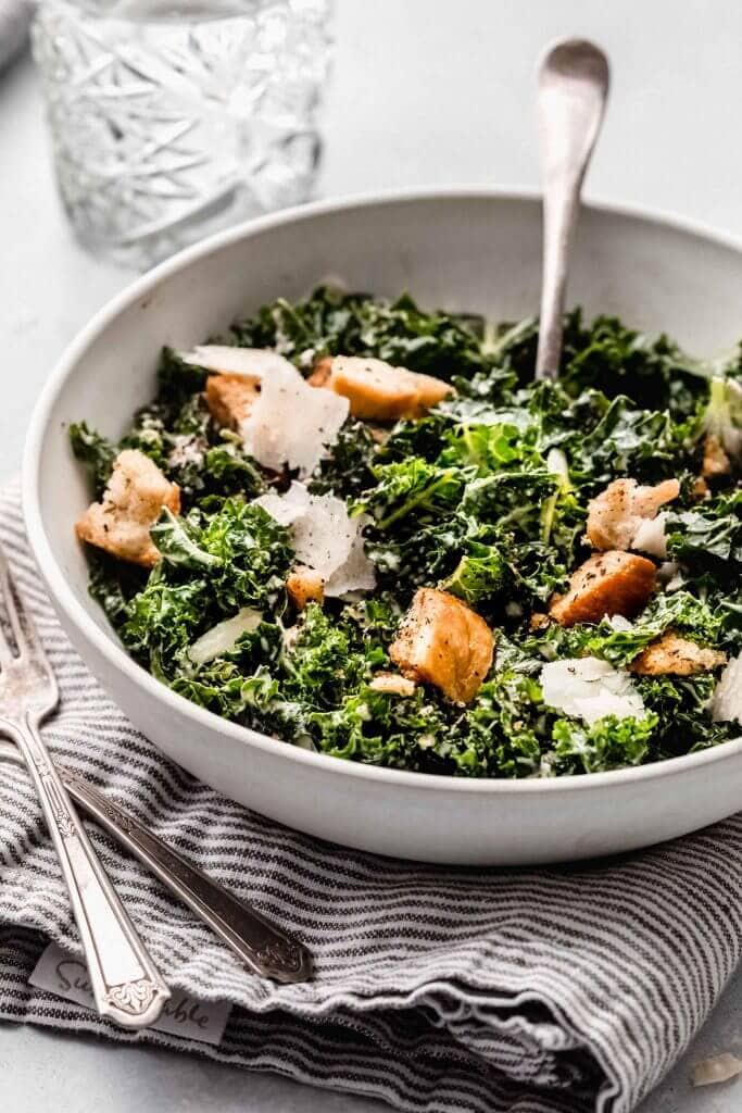 Side view of bowl of caesar salad.