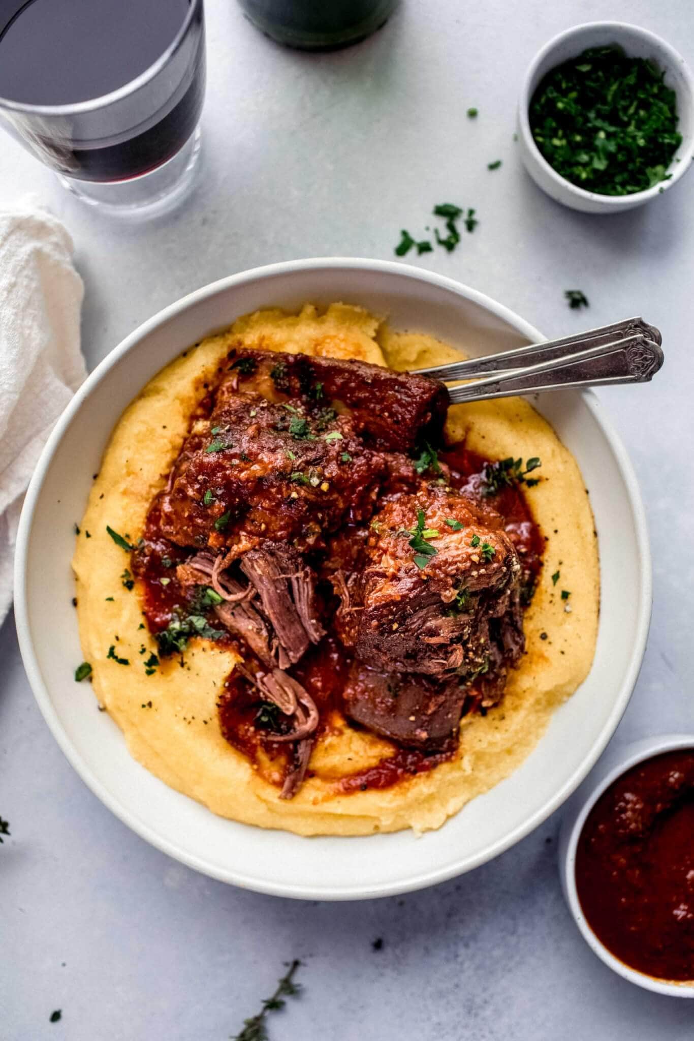 red wine braised short ribs and mashed potatoes in white bowl