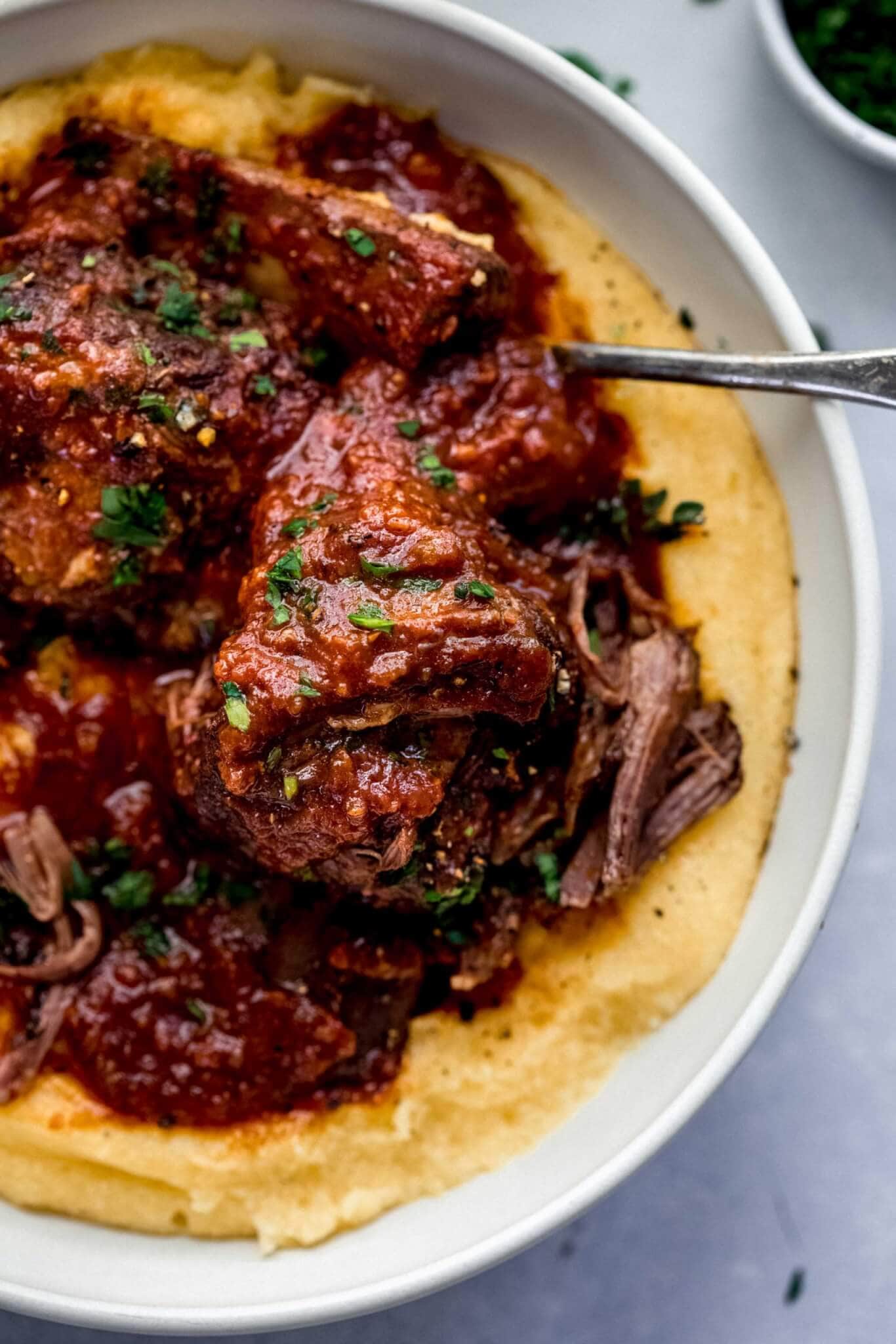 short ribs and mashed potatoes in white bowl