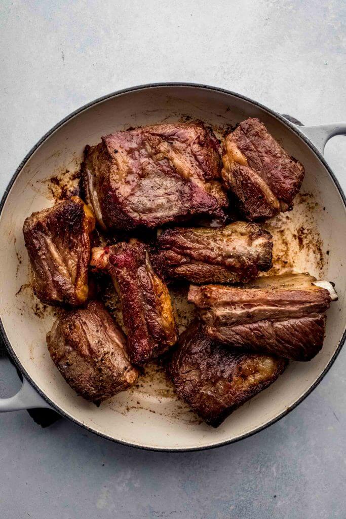 top shot of cooked short ribs in dutch oven