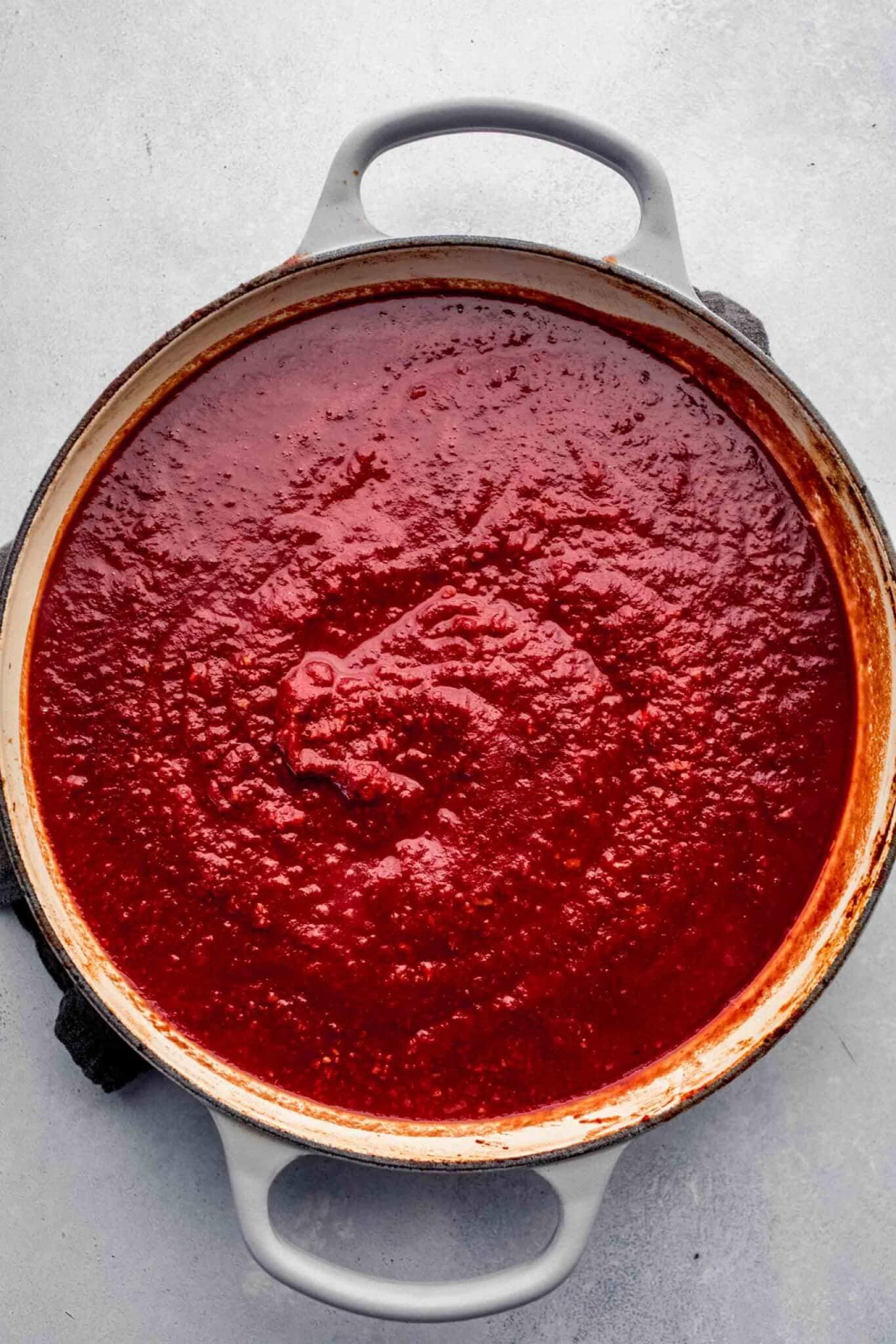 top shot of red sauce puree in dutch oven