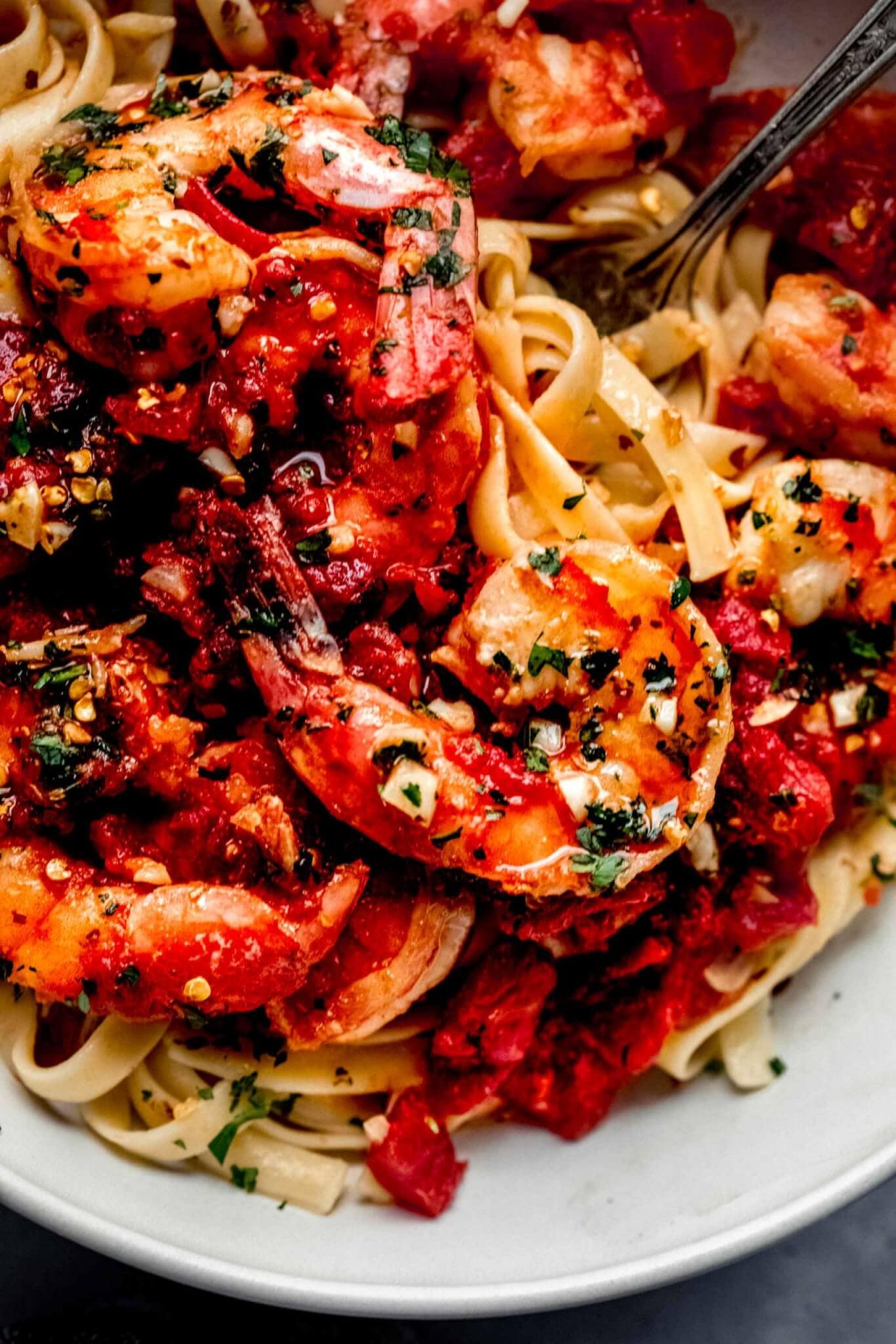 Overhead close up of fra diavolo served over pasta in bowl.