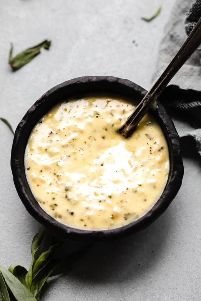 Overhead shot of bearnaise in small black bowl.