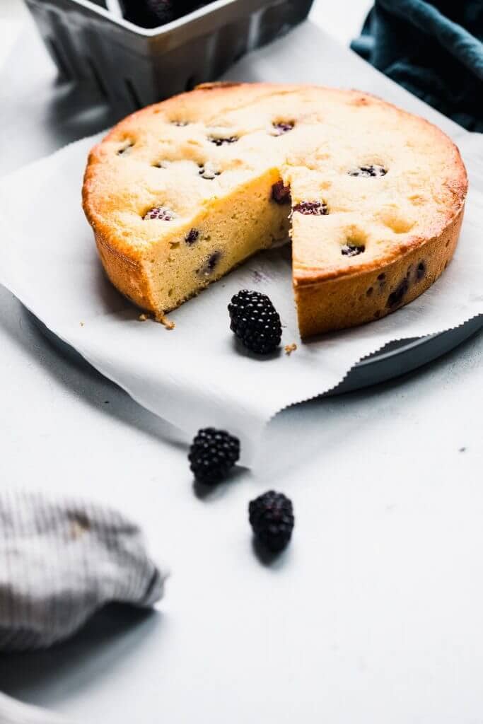 Side view of ricotta cake with slice taken out. 