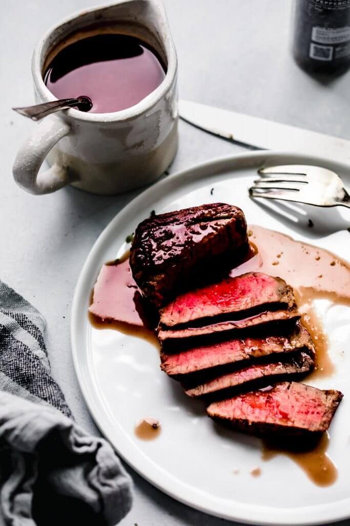 Steak drizzled with red wine jus. 