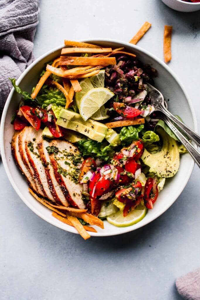 Overhead shot of sw chicken salad in bowl with two forks.