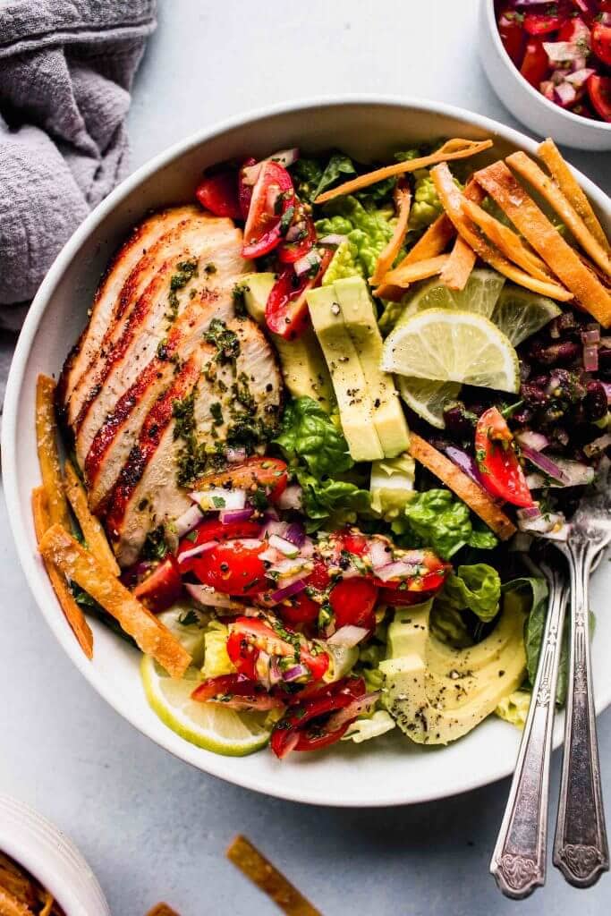 Overhead shot of sw chicken salad in bowl with two forks. 