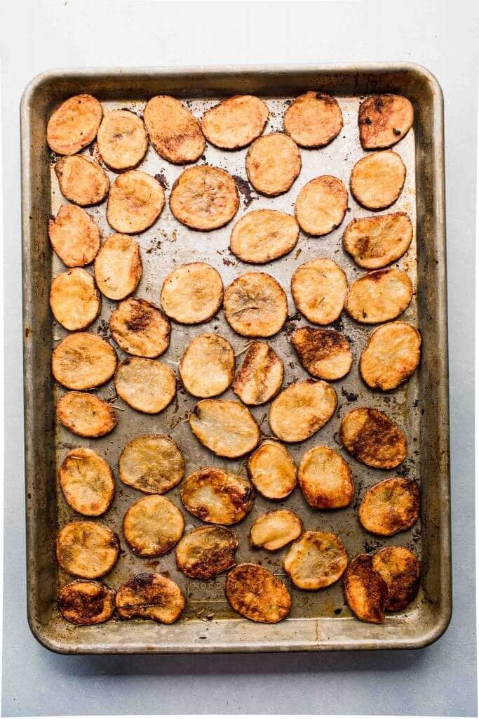 Baked potato slices on sheet pan. 