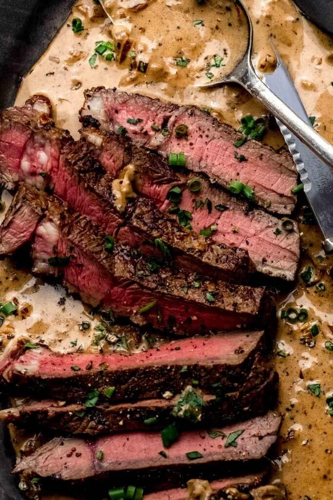 Close up of steak in diane sauce. 