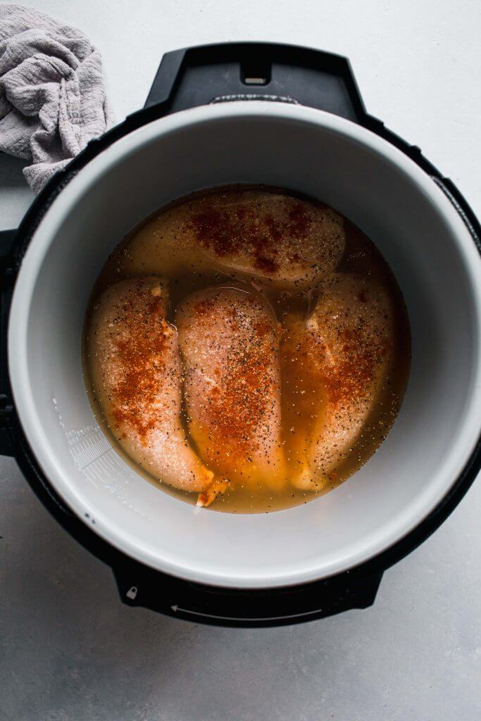 Seasoned chicken in instant pot with broth