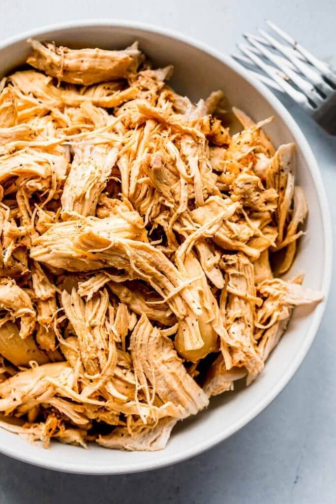 Close up of shredded chicken in bowl. 