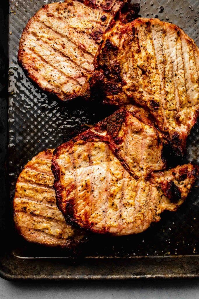 Grilled pork chops on tray. 