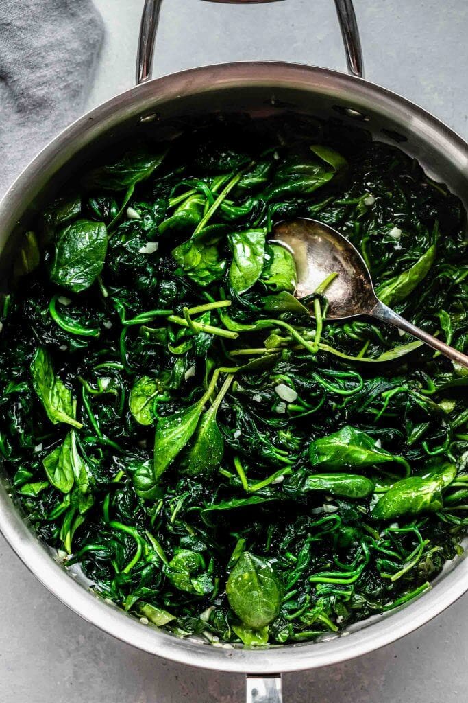 Sauteed spinach in large skillet.