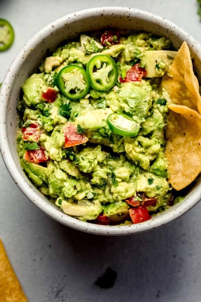 BOWL OF GUACAMOLE TOPPED WITH SLICED JALAPENOS. 