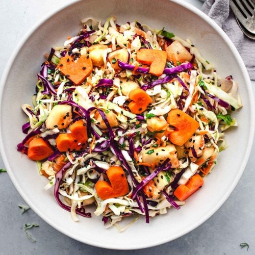 Hawaiian coleslaw in white serving bowl.