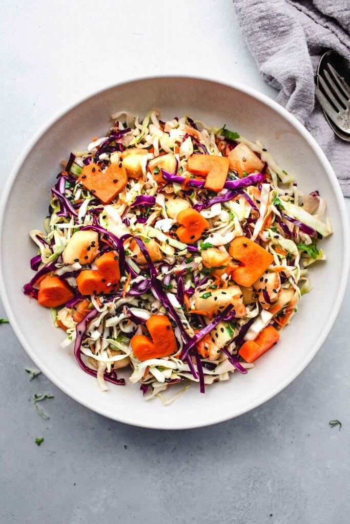 Hawaiian coleslaw in white serving bowl. 