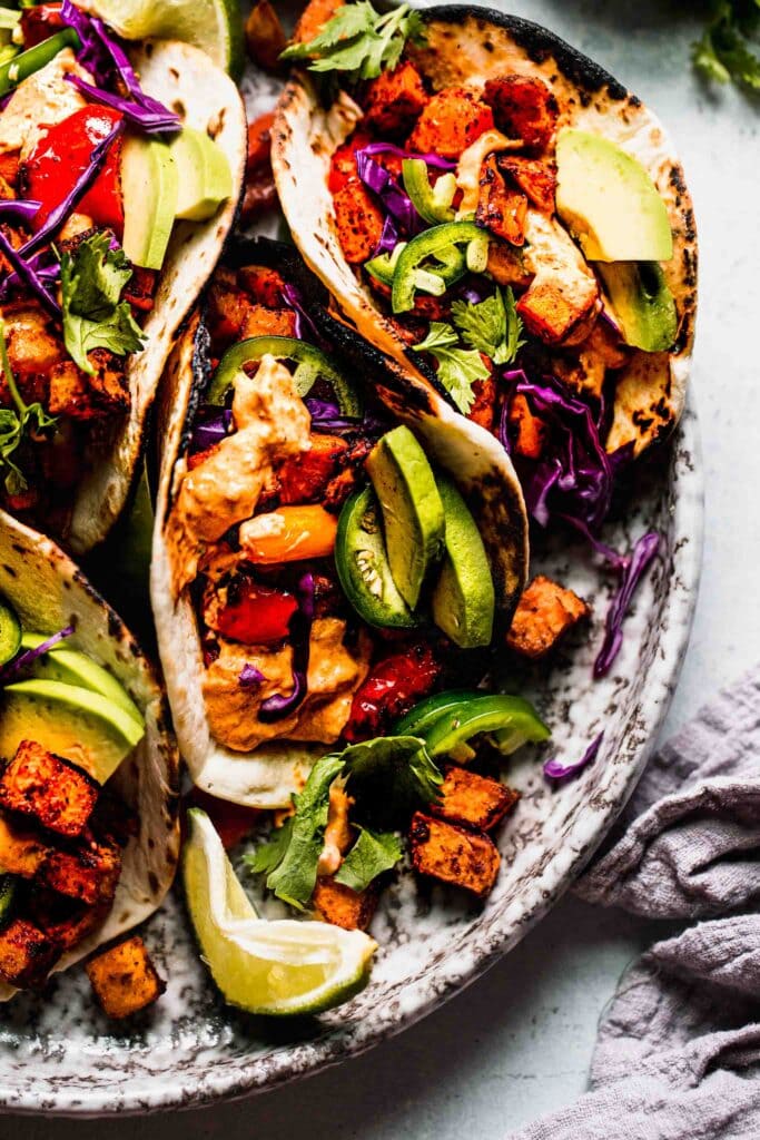 Roasted red pepper and sweet potato tacos on plate. 