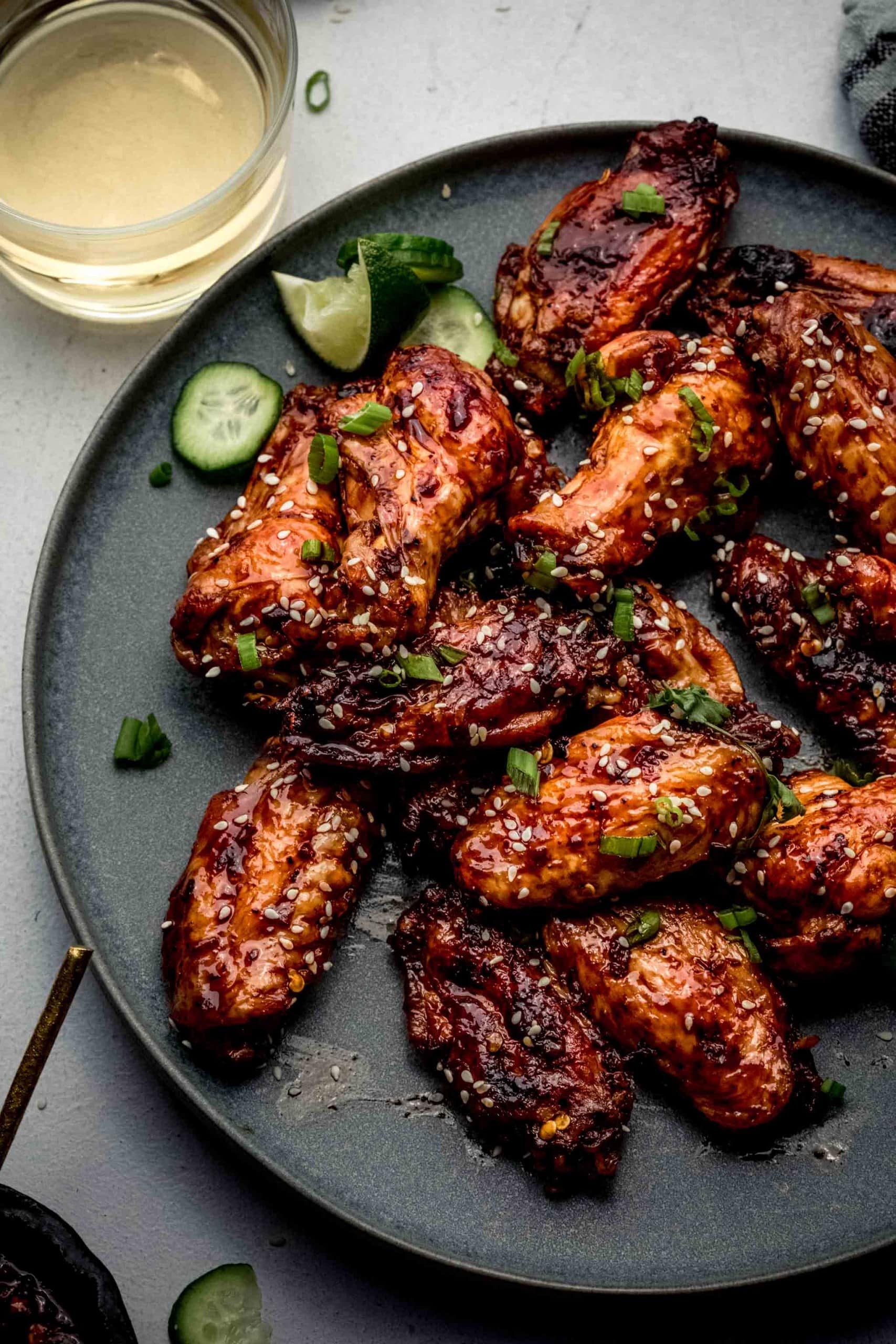 Chinese chicken wings arranged on grey plate.