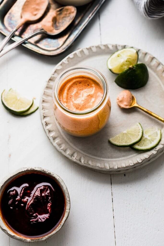 Jar of quesadilla sauce next to bowl of chipotles. 