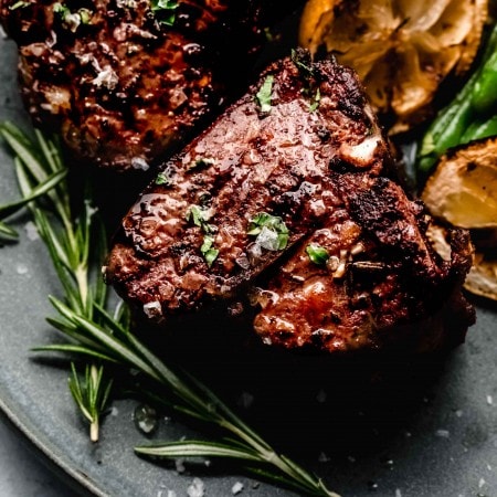 Close up of grilled lamb chops with rosemary.