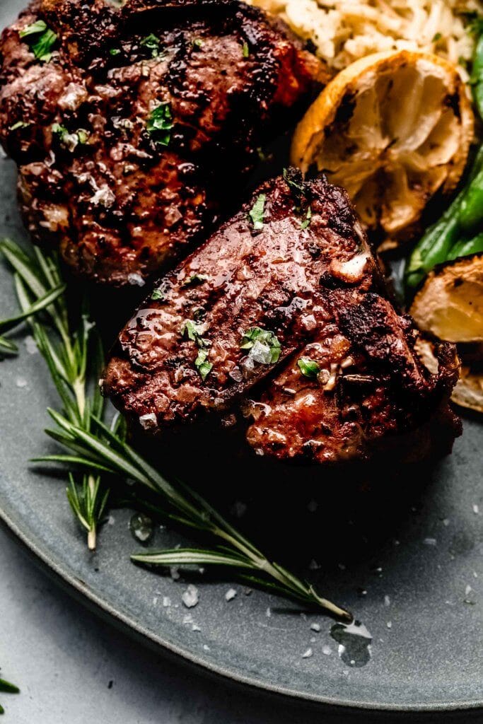 Close up of grilled lamb chops with rosemary.