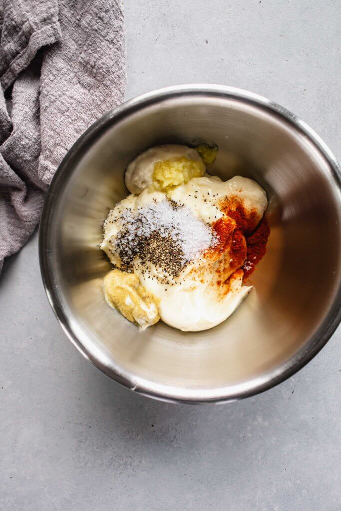 Ingredients for white bbq sauce in bowl.