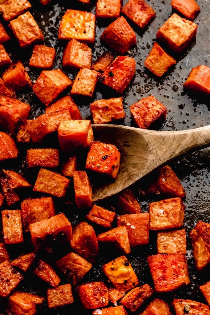 Roasted sweet potatoes on baking tray. 