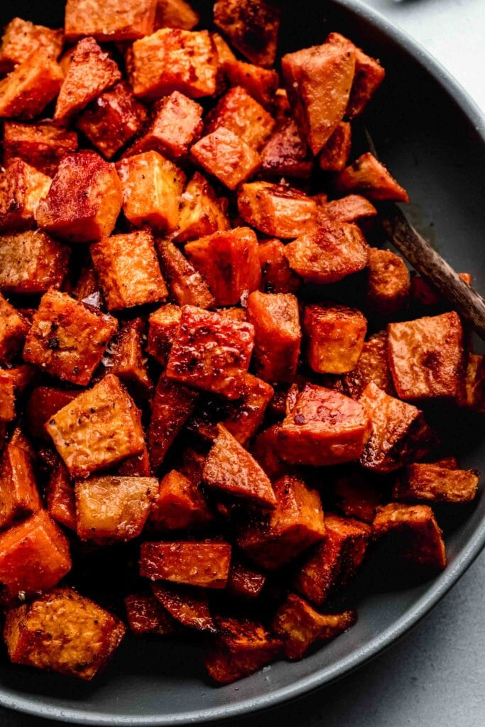 Roasted sweet potatoes in grey serving bowl. 
