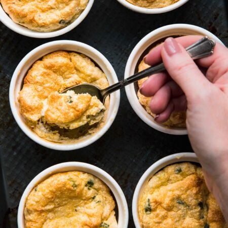 Hand scooping into spoon bread.