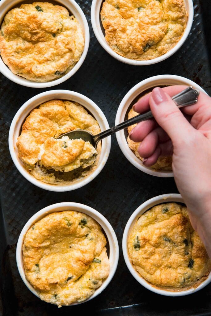 Hand scooping into spoon bread.