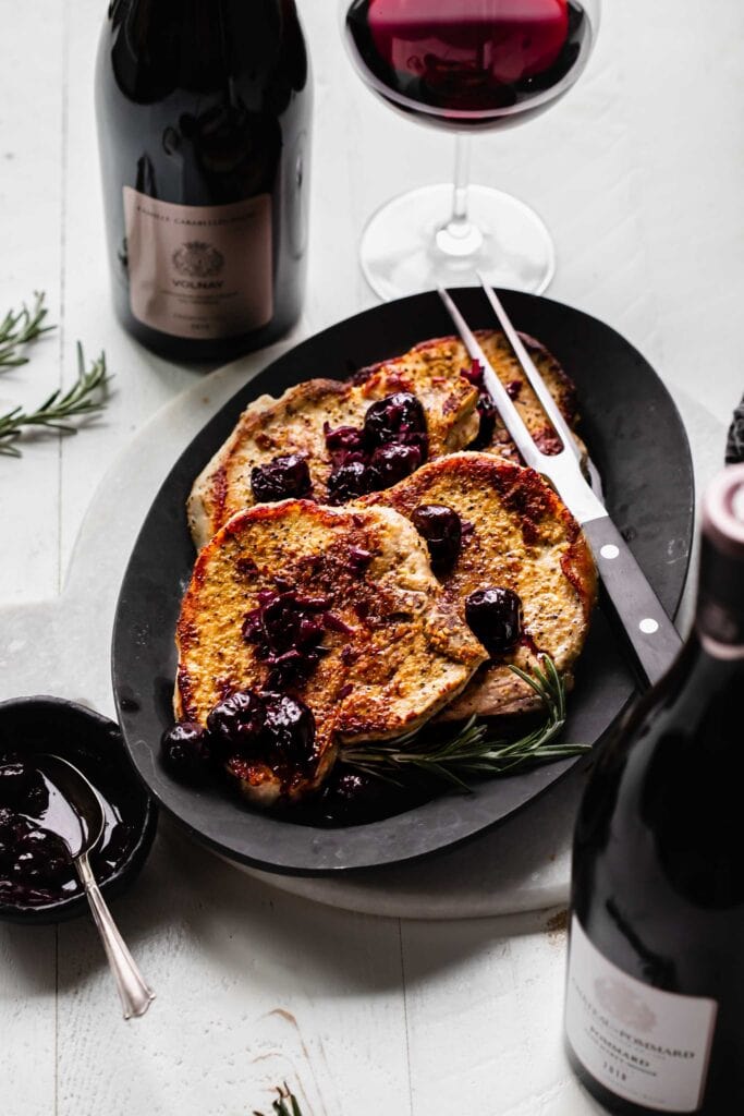 Pork chops topped with cherry sauce. 