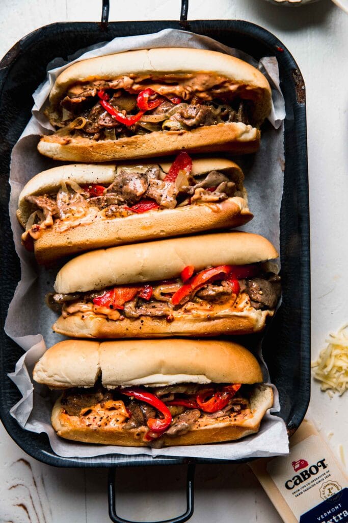 Cheesesteaks on serving tray.