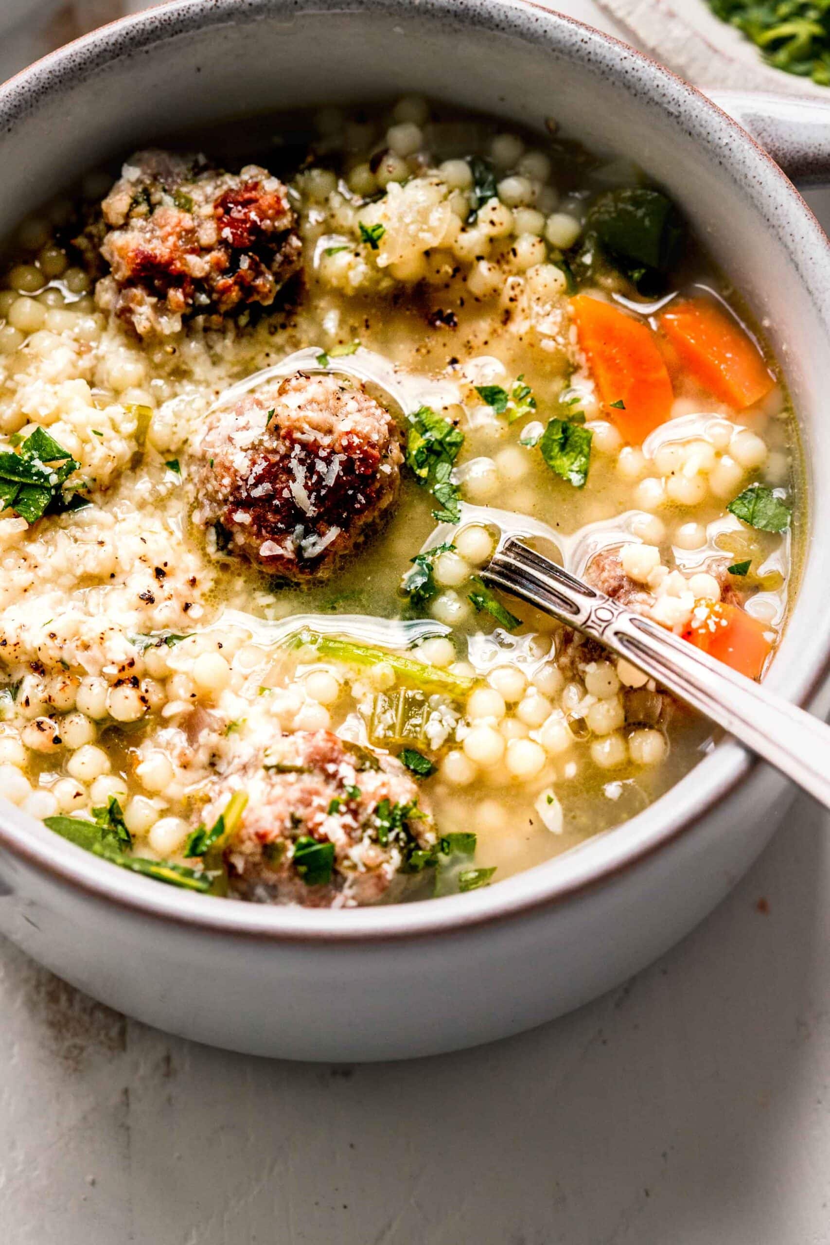 Bowl of wedding soup with spoon.