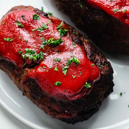 Air fryer meatloaf on white serving plate.