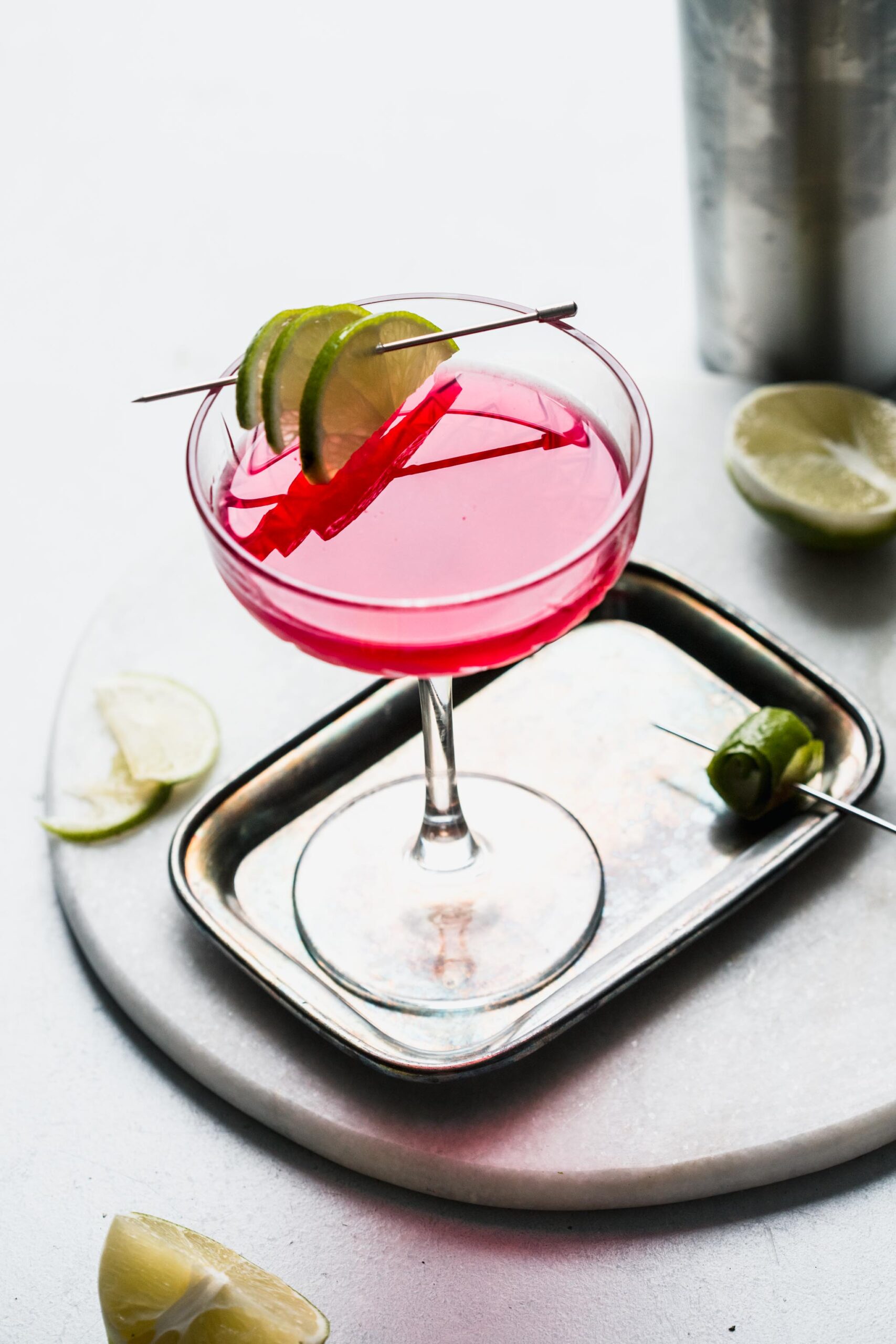 Overhead shot of cosmopolitan cocktail on serving tray.