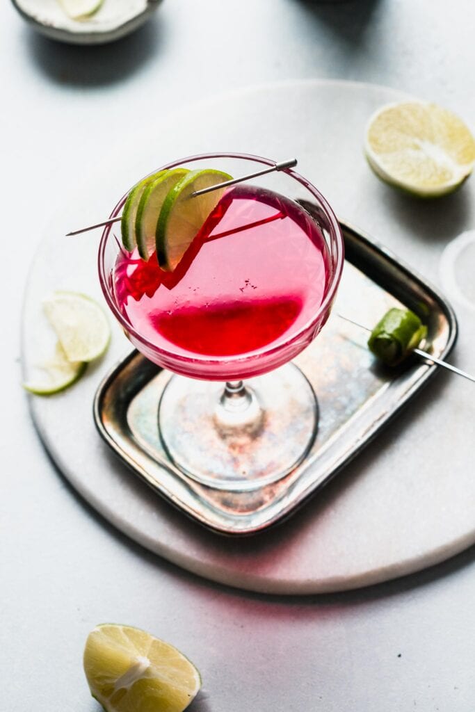 Overhead shot of cosmopolitan cocktail on serving tray.